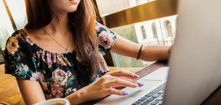 A woman working at a laptop